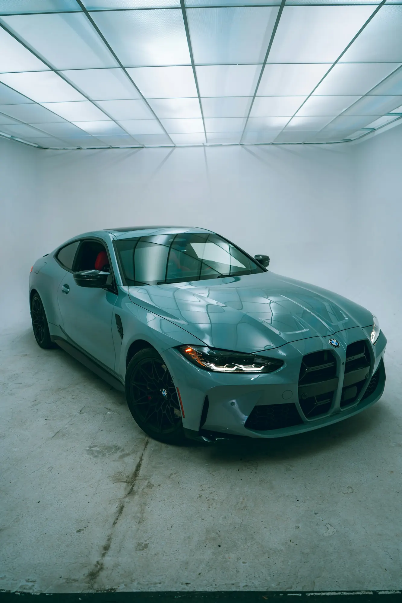 Car in a studio, used to demonstrate tint darkness on the glass